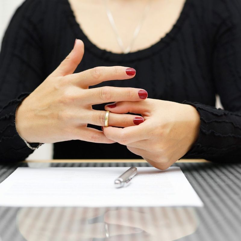Woman taking off wedding ring