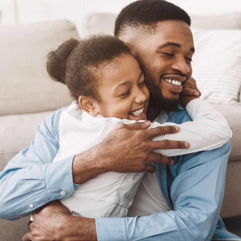 Man hugging young daughter