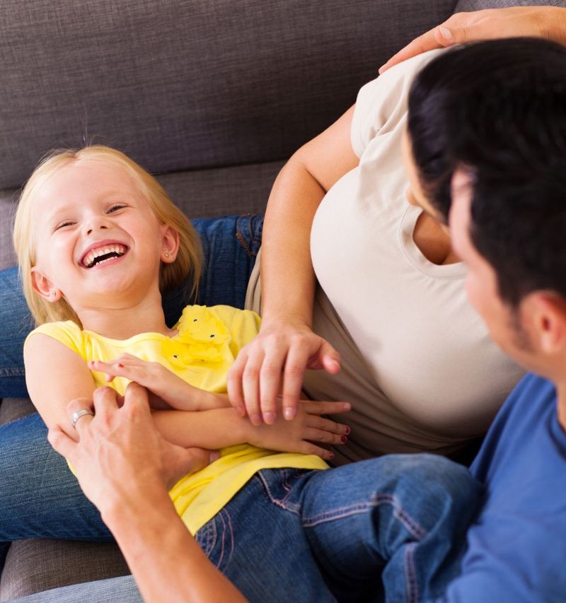 Father and young daughter laughing