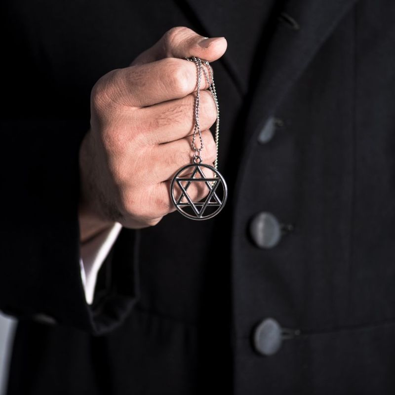 Jewish man holding Star of David necklace