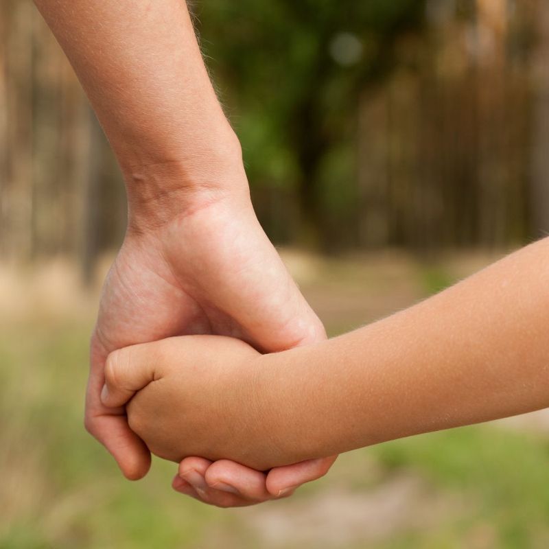 parent_son Parent and son holding hands outside